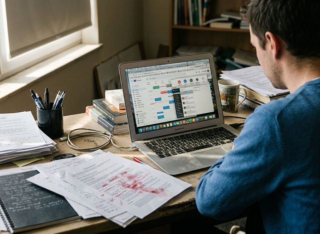 Candid shot of Editorial desk with notes and drafts on therapist CEU comparisons